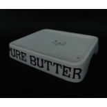 An early 20thC style white ceramic 'Pure Butter' advertising display tray, bears traces of