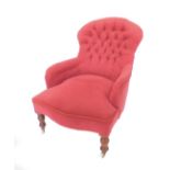 A Victorian mahogany spoon back nursing chair, with button back red dralon upholstery, raised on