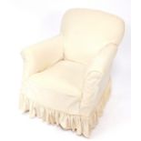 A Victorian ebonised nursing chair, with a cream loose cover, raised on tapering square legs, on