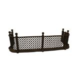 An early 19thC cast iron fender, with lattice work and guilloche castings to the front, with ball