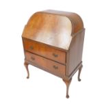 An Art Deco walnut and mahogany bureau, the domed top with front opening to reveal eight recesses