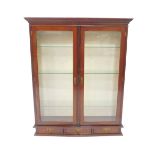 An Edwardian mahogany wall mounted display cabinet, the outswept pediment with dentil moulding, over