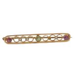 An early 20thC gold suffragette brooch, set with a peridot, amethyst and seed pearls, one seed pearl