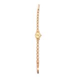 A lady's 9ct gold cased wristwatch, oval champagne dial bearing gold batons, the case with bow