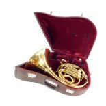 A Parrot brass French horn, cased.