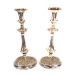 A pair of early 19thC Old Sheffield Plate candlesticks, embossed with flowers and scrolling