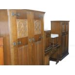 A 20thC oak bedroom suite, with Gothic tracery and linenfold carved panelling, comprising a double