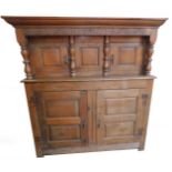 A George II oak court cupboard, with later alterations, the outswept pediment over a leaf carved