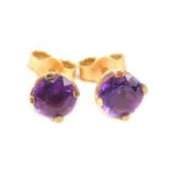 A pair of amethyst stud earrings, each stone round brilliant cut, in claw setting, with enclosed