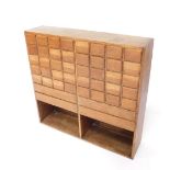 An oak modernist spice chest, of rectangular form, the front with forty small drawers and four