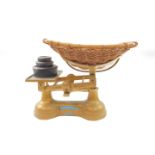 A set of Treasure Cot Company Ltd gold painted cast iron baby scales, to weigh 28lbs, with three