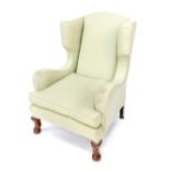 A Georgian style mahogany framed wingback armchair, upholstered in green herringbone fabric, 102cm