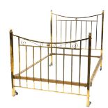 A late Victorian brass bed head and foot, with short turned finials, scrolls to the headboard, and