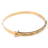 A Victorian two colour gold belt and buckle bangle, with engine turned decoration, 9.6g.