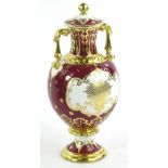 A Royal Crown Derby porcelain two handled vase and cover, decorated with a scene of Blenheim Palace,