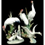 A collection of Lladro birds, to include a group of two storks, a single stork, and various geese.