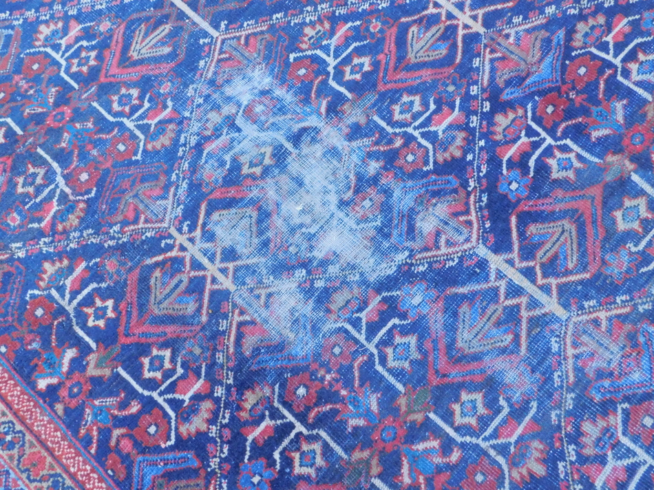 A Persian carpet, with an all over multi coloured design on a navy - Image 2 of 4