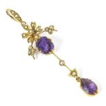 An Edwardian amethyst and seed pearl pendant, set with two amethyst stones and a floral cluster of