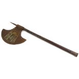 An iron and hardwood axe, decorated to the iron blade with figures within a tent etc., and