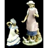 A Lladro porcelain figure, of a lady wearing a purple pinafore, feeding some doves, printed mark