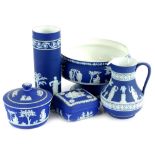 A collection of dark blue Jasperware, to include a bowl, cylindrical vase, bowl and cover, jug and a