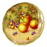 A Royal Worcester porcelain plate, decorated with fruit by Freeman, within a gilt border, printed