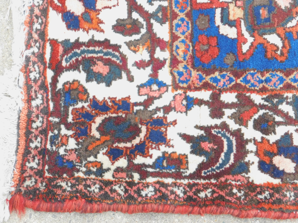 A Persian carpet, with an all over design of flowers, on a red ground with multiple borders, 314cm x - Image 2 of 3