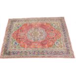 A Persian design rug, with a central medallion in grey, with a red field decorated with leaves,