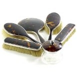 A George V silver and tortoiseshell backed dressing table set, comprising two hair brushes, 23cm