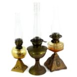 Three late 19th/early 20thC oil lamps, to include an example with a facetted clear glass reservoir