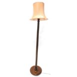 A turned mahogany standard lamp, with a fluted column on bun feet, 189cm H including shade.