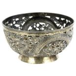 A Chinese white metal bowl, with pierced decoration cast with dragons etc., signed to underside