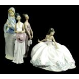 A collection of four Lladro porcelain figures, to include a lady with a large evening of wedding