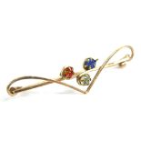A tri-colour bar brooch, set with three paste stones, red, white and blue, on yellow metal thin