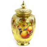 A Royal Worcester porcelain vase and cover, decorated with fruit by Paul English, the pierced lid