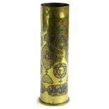 A First World War German brass shell case, decorated in coloured metals with Arabic writing, stars