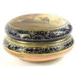 A Noritake porcelain box and cover, the lid painted with an Arabic scene of a camel, palm trees,