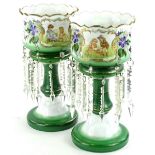 A pair of Victorian green and white opaque glass table lustres, each with a printed design of