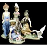 A collection of four Lladro porcelain figures, to include a girl picking flowers and another being