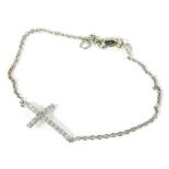 An 18ct white gold crucifix bracelet, with diamond set crucifix, on fine link chain, 19cm long, 2.4g