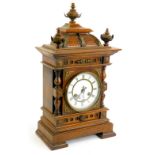 A late 19thC Junghans walnut and brass mantel clock, the case with acorn type finial's, turned