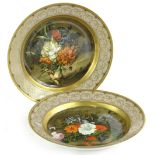 A pair of Kaiser flower bouquet porcelain plaques, each decorated with an old master scene after