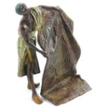 A cold painted bronze model of an Arab carpet seller, bearing stamp to reverse, Bergman, 12cm H,