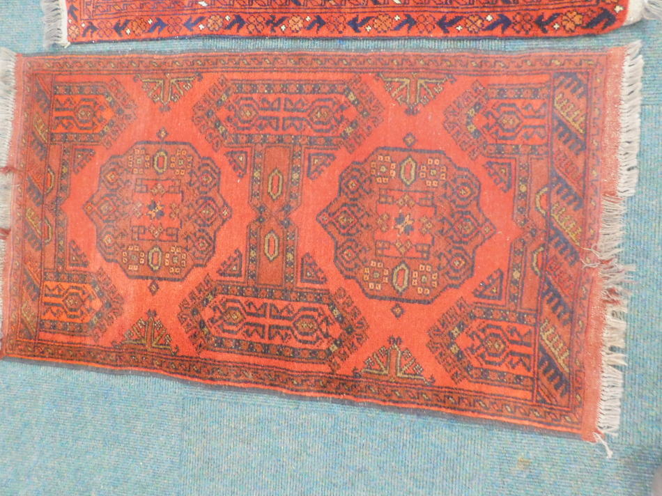 Two Turkish design small rugs, each with a design of medallions on a red ground, 94cm x 54cm and - Image 2 of 4