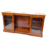 A Victorian walnut and marquetry inverted break front bookcase, the top with a moulded edge above