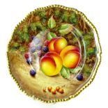 A Royal Worcester porcelain plate, decorated with fruit by F Higgins, with gilt borders, printed