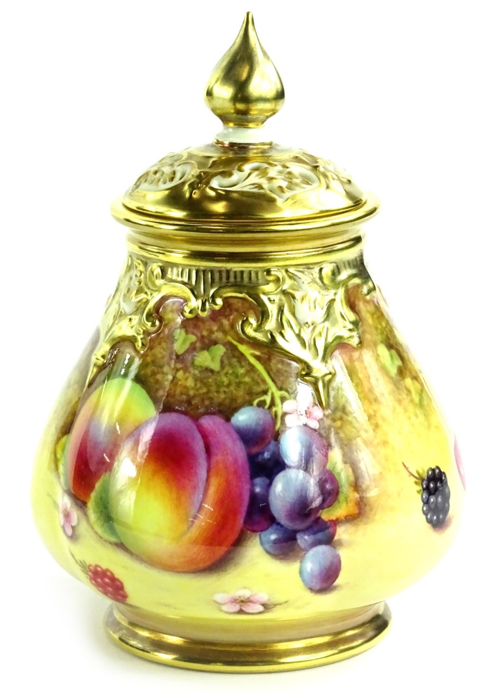 A Royal Worcester porcelain vase and cover, with a pierced lid, the base decorated with fruit by P