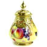A Royal Worcester porcelain vase and cover, with a pierced lid, the base decorated with fruit by P