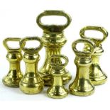 A graduated set of brass bell shaped weights, 17cm H etc. (a quantity)