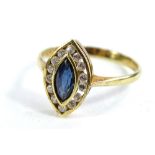 A marquise shaped dress ring, set with central pale blue stone, possibly tanzanite, with tiny